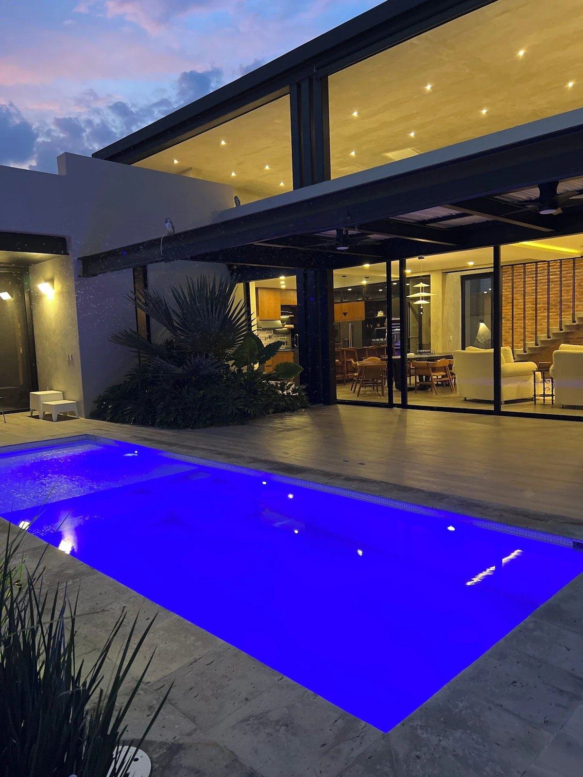 The pool and the lit house
